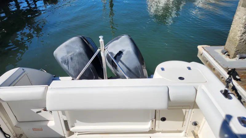 Slide: The Image of 2001 Boston Whaler 26 Outrage boat with dual outboard motors on calm water. - 6