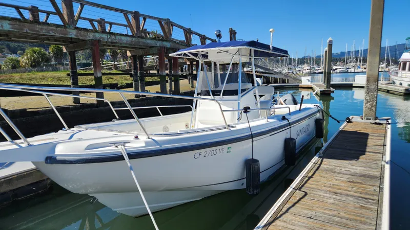 Slide: The Image of 2001 Boston Whaler 26 Outrage boat docked at marina under clear blue sky. - 7