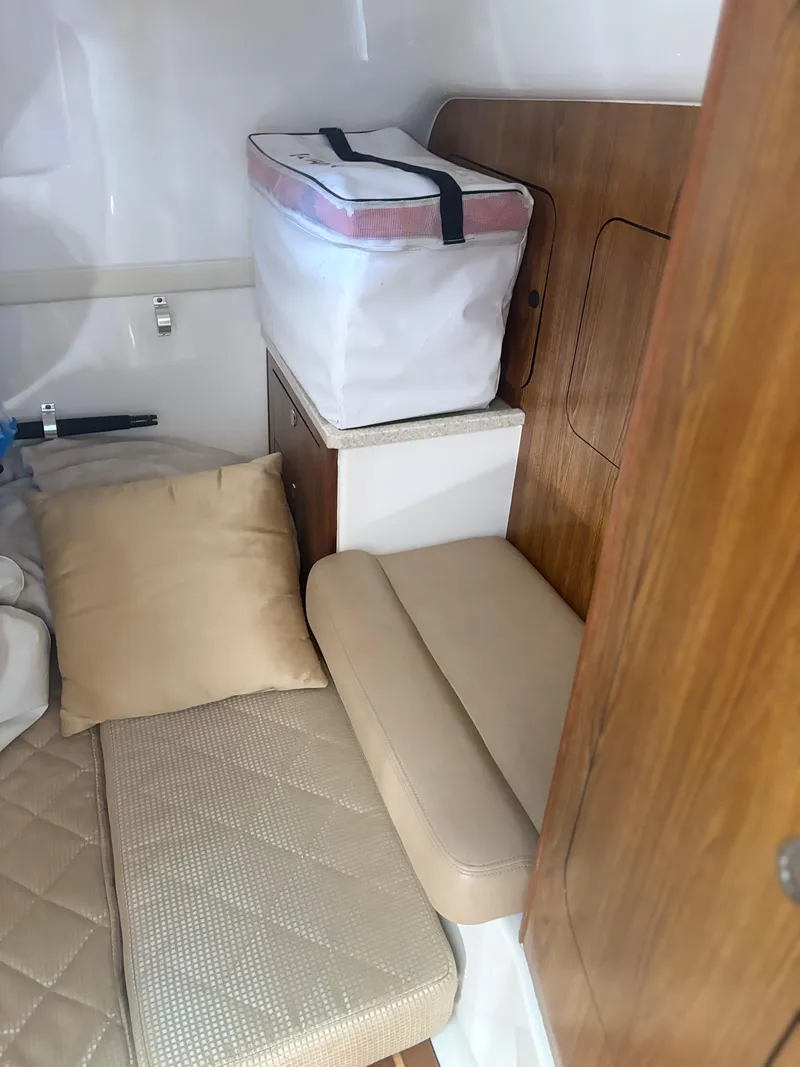 Slide: The Image of Interior cabin of 2012 Pursuit OS 345 Offshore with seating and storage. - 13