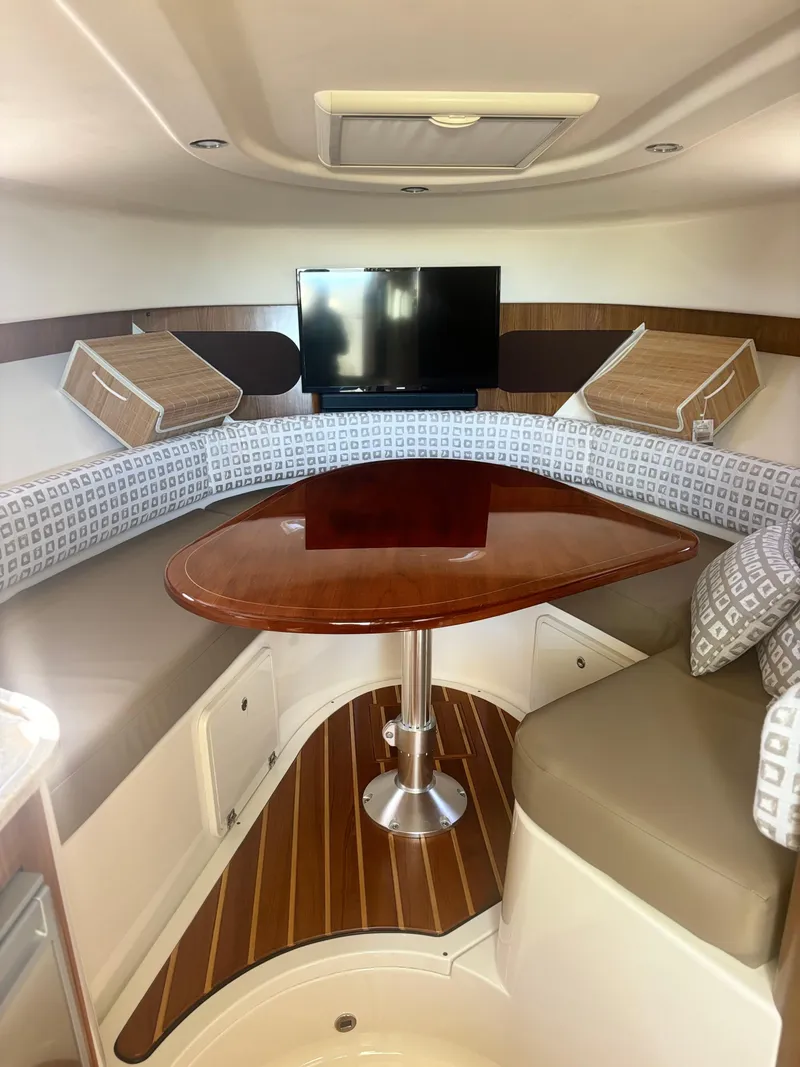 Slide: The Image of Interior of 2012 Pursuit OS 345 Offshore boat with cozy seating and TV. - 15