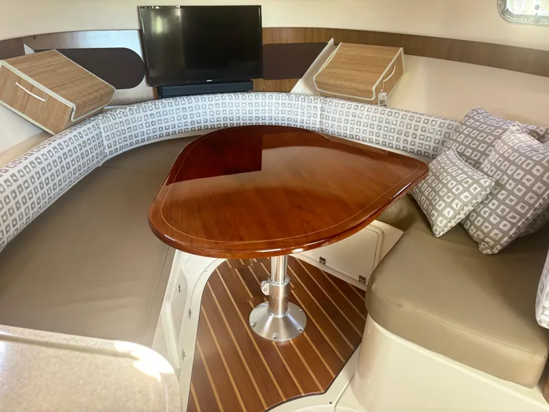 Slide: The Image of Luxurious interior of 2012 Pursuit OS 345 Offshore boat with elegant seating and table. - 16