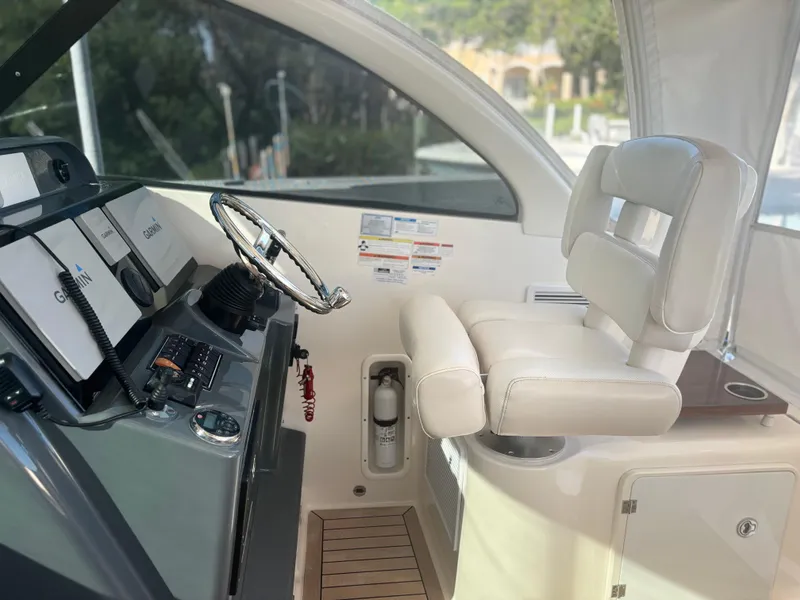 Slide: The Image of Interior helm of 2012 Pursuit OS 345 Offshore boat with steering wheel and controls. - 5