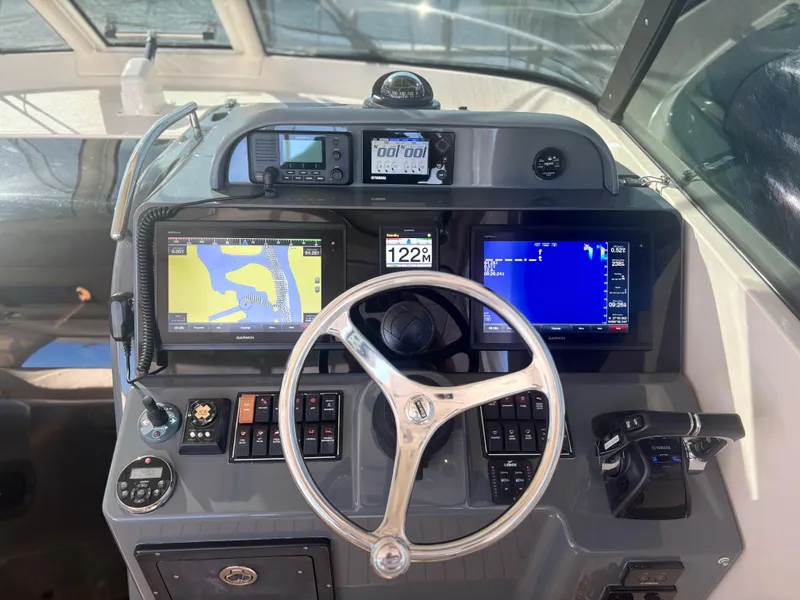 Slide: The Image of 2012 Pursuit OS 345 Offshore boat dashboard with navigation and control systems. - 8