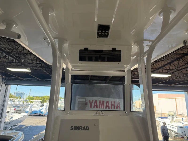 Slide: The Image of 2025 NauticStar 252 Legacy boat interior with Simrad electronics and Yamaha branding. - 10