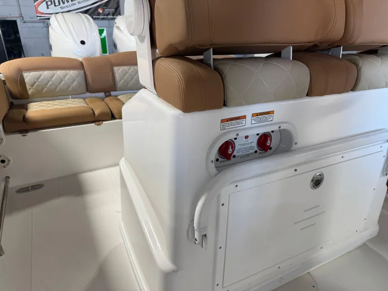 Slide: The Image of 2025 NauticStar 252 Legacy boat interior with tan seating and control panel. - 16