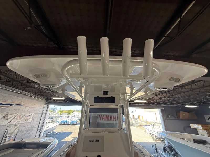 Slide: The Image of 2025 NauticStar 252 Legacy boat interior with rod holders and electronics. - 9