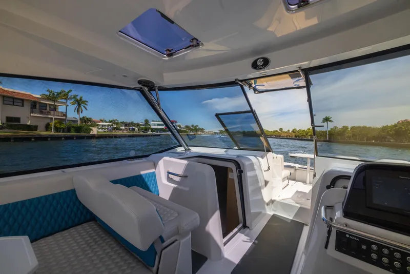 Slide: The Image of Interior view of 2019 Aquila 36 Sport boat with modern seating and scenic waterway. - 17