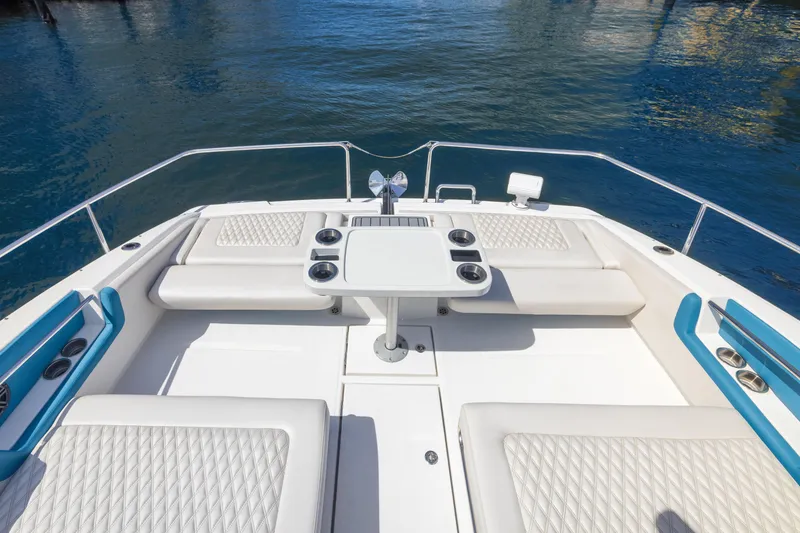 Slide: The Image of Aquila 36 Sport 2019 boat deck with seating and table on calm water. - 18