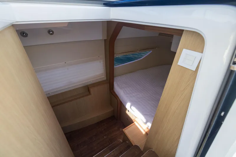 Slide: The Image of Interior cabin of 2019 Aquila 36 Sport boat with wooden finish and cozy bed. - 22