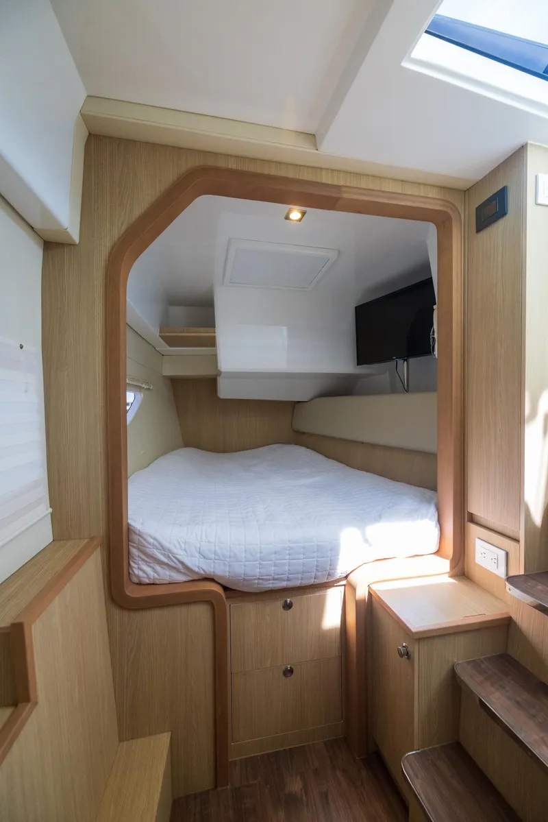 Slide: The Image of Interior cabin of 2019 Aquila 36 Sport yacht with bed and wooden furnishings. - 23