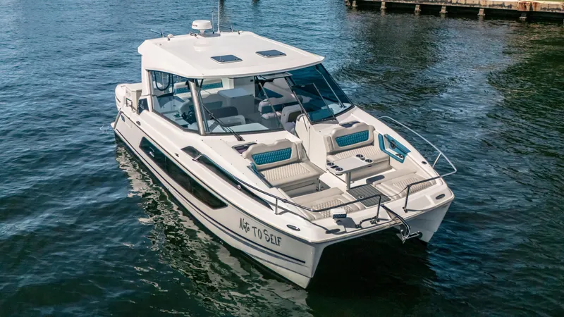 Slide: The Image of 2019 Aquila 36 Sport boat on water, featuring sleek design and spacious deck. - 27