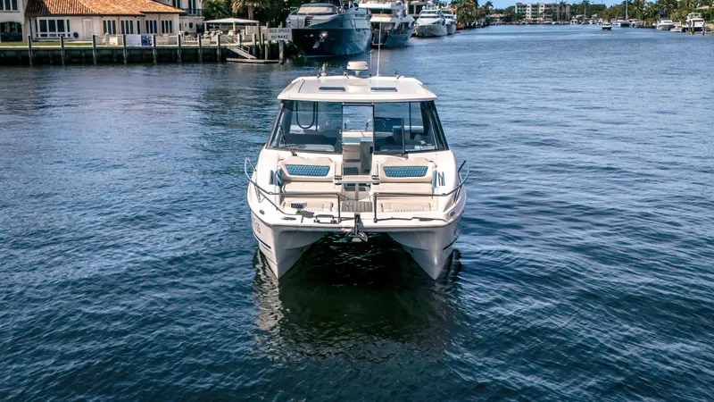 Slide: The Image of 2019 Aquila 36 Sport catamaran on calm water, dockside view. - 4