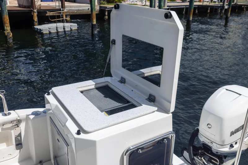 Slide: The Image of Open storage compartment on 2019 Aquila 36 Sport boat, dockside view. - 9
