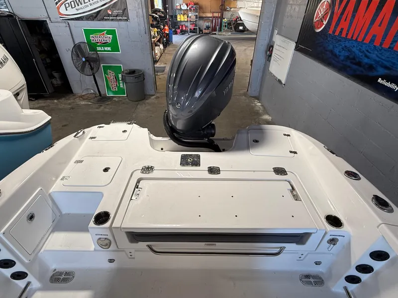 Slide: The Image of 2025 NauticStar 251 Hybrid boat with Yamaha outboard motor in a workshop setting. - 4