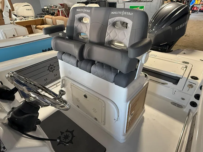 Slide: The Image of 2025 NauticStar 251 Hybrid boat interior with dual seats and steering wheel. - 5
