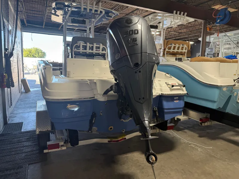 Slide: The Image of 2025 NauticStar 251 Hybrid boat with 300 V6 engine in a storage facility. - 6