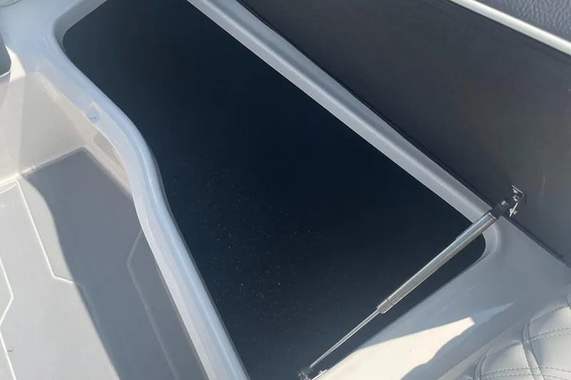 Slide: The Image of 2025 Regal LS4 Surf boat storage compartment, open and empty. - 11