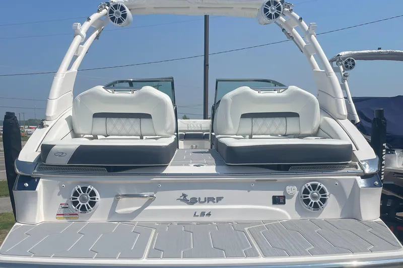 Slide: The Image of 2025 Regal LS4 Surf boat, rear view with seating and speakers. - 18
