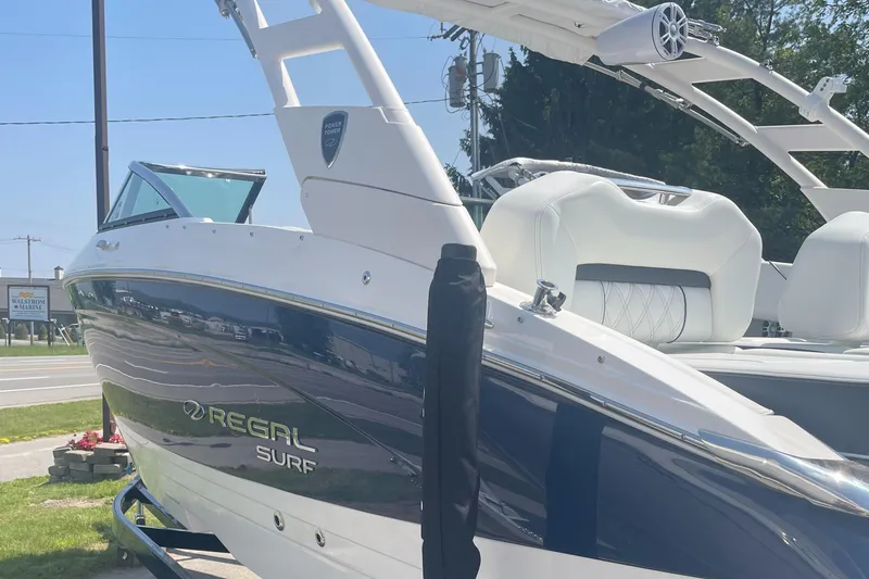Slide: The Image of 2025 Regal LS4 Surf boat with sleek design and modern features, displayed outdoors. - 3