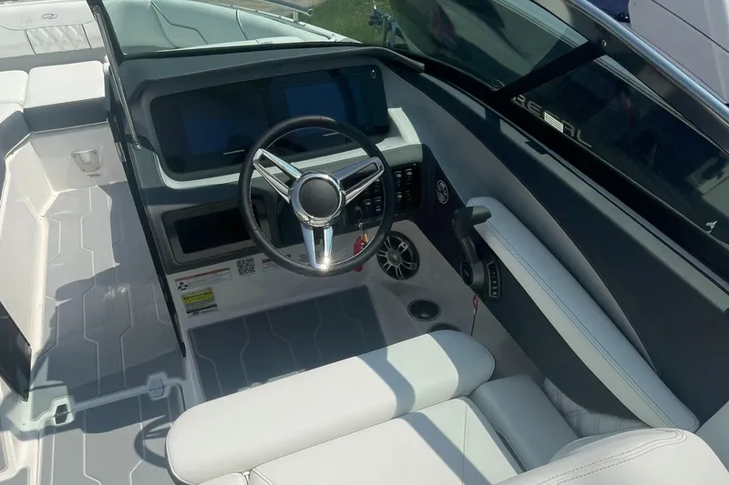 Slide: The Image of 2025 Regal LS4 Surf boat cockpit with modern steering and dashboard controls. - 6