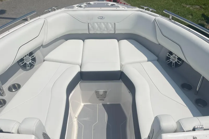 Slide: The Image of 2025 Regal LS4 Surf boat interior with white cushioned seating and cup holders. - 7