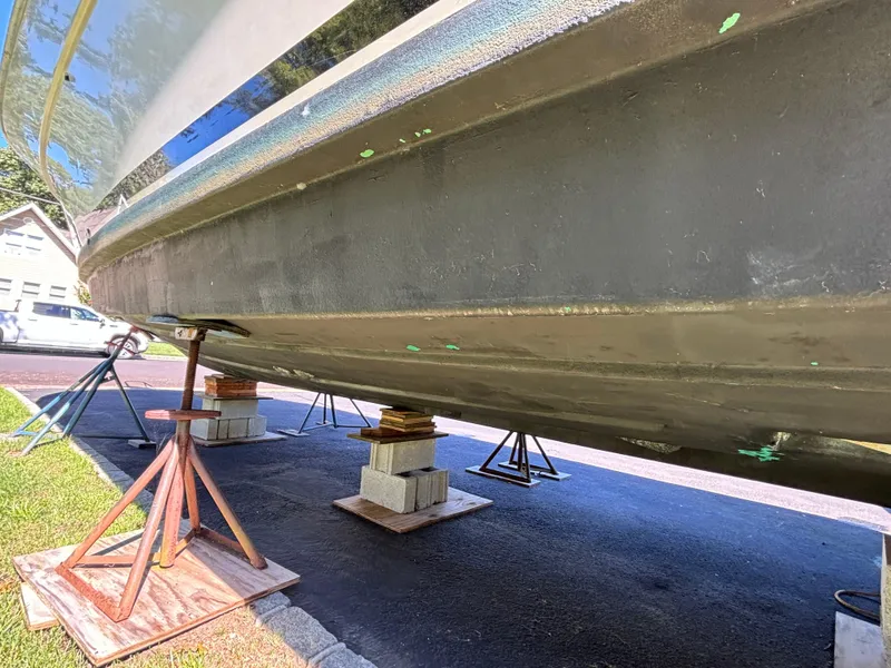 Slide: The Image of 1984 Viking Express Cruiser on blocks, showing hull and support stands. - 12