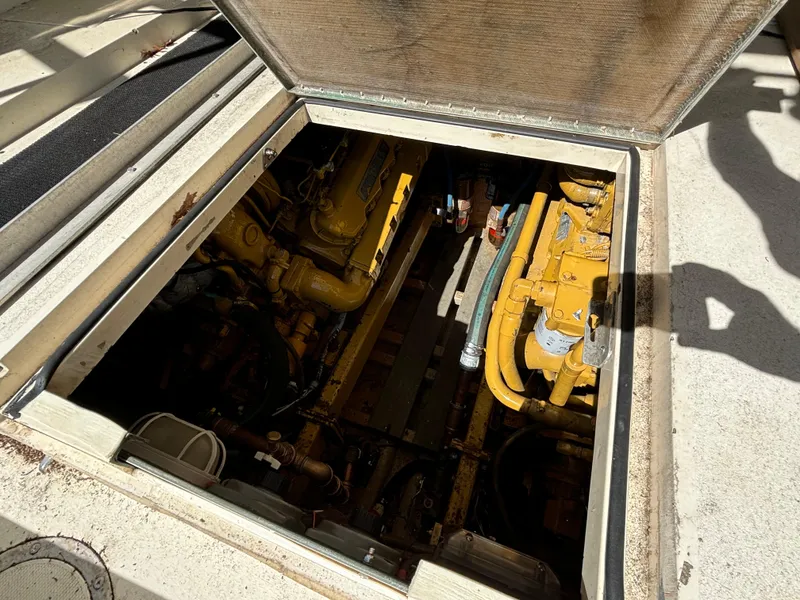 Slide: The Image of Engine compartment of a 1984 Viking Express Cruiser, showcasing yellow machinery and components. - 8