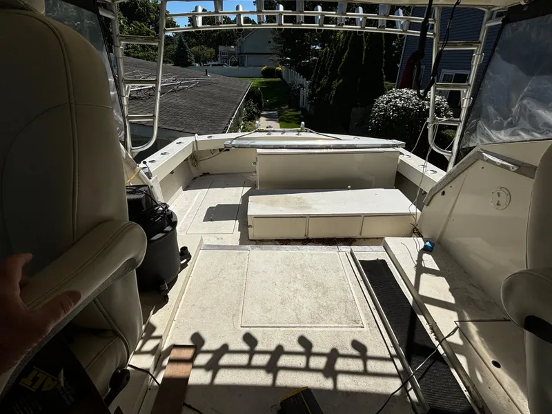 Slide: The Image of 1984 Viking Express Cruiser boat interior with seating and open deck. - 9