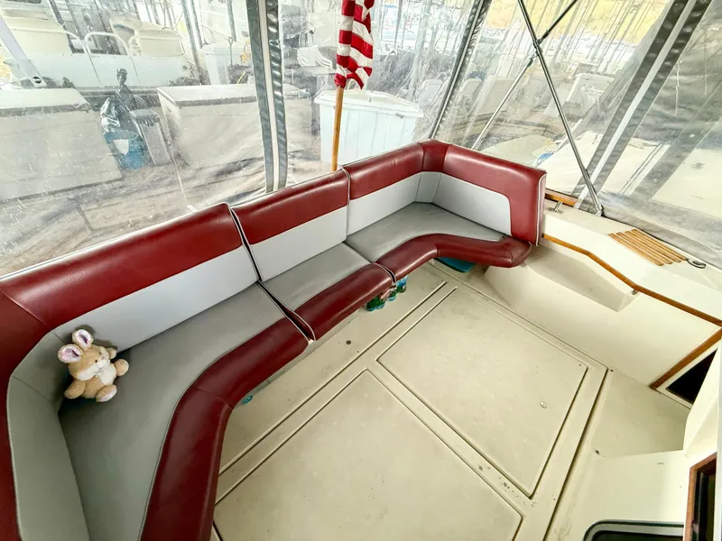 Slide: The Image of 1986 Cruisers Yachts 297 Elegante interior with red and gray seating, American flag decor. - 10