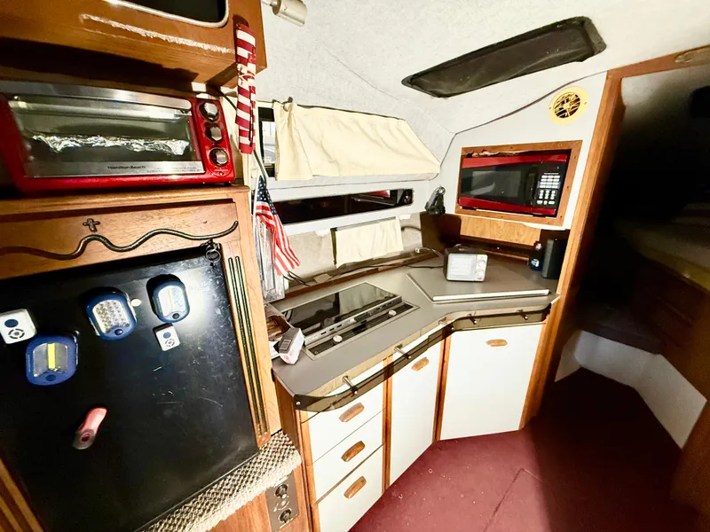 Slide: The Image of 1986 Cruisers Yachts 297 Elegante interior with kitchenette and storage cabinets. - 11