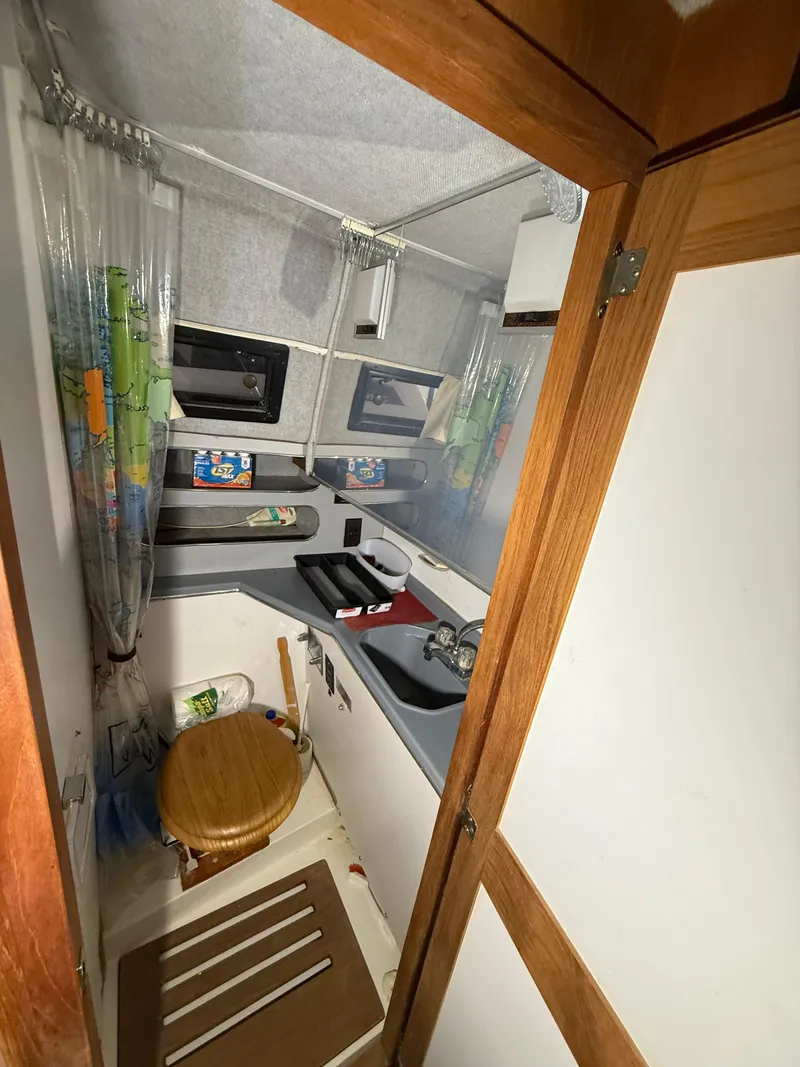 Slide: The Image of 1986 Cruisers Yachts 297 Elegante bathroom with wooden accents and compact design. - 20