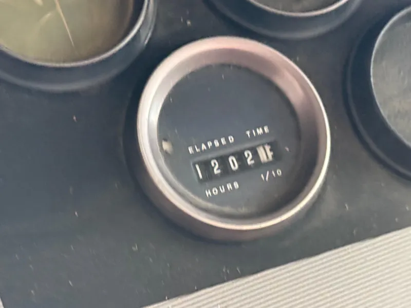 Slide: The Image of Hour meter showing 1202 hours on 1986 Cruisers Yachts 297 Elegante. - 22