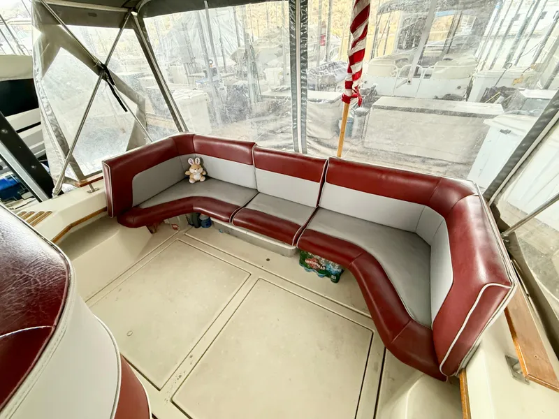 Slide: The Image of 1986 Cruisers Yachts 297 Elegante interior with red and gray seating. - 9