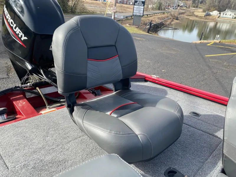 Slide: The Image of 2022 Tracker Pro Team 175 TXW boat seat with Mercury engine, near a lake. - 15