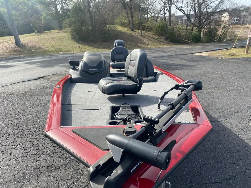 Slide: The Image of 2022 Tracker Pro Team 175 TXW boat with red exterior, parked on asphalt. - 19