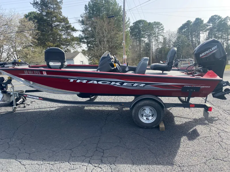 Slide: The Image of 2022 Tracker Pro Team 175 TXW boat on trailer, red color, parked outdoors. - 21