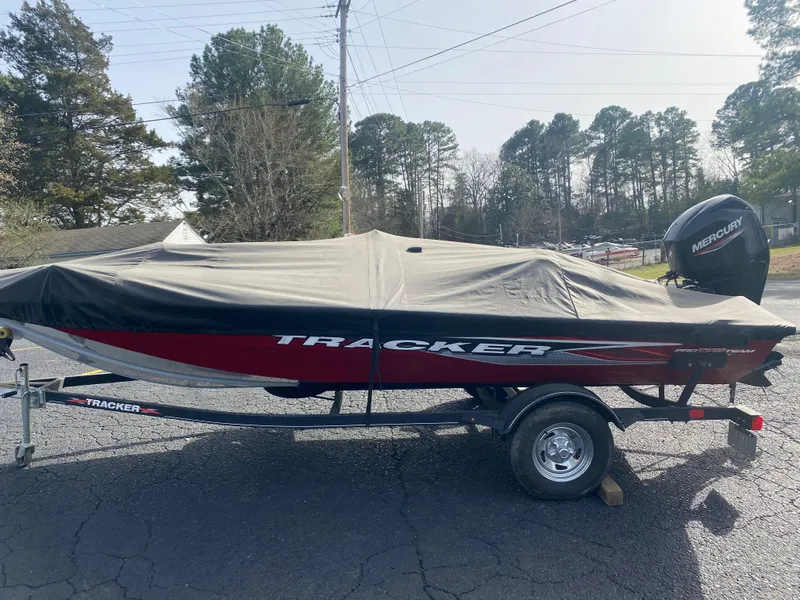 Slide: The Image of 2022 Tracker Pro Team 175 TXW boat with cover on trailer, parked outdoors. - 4