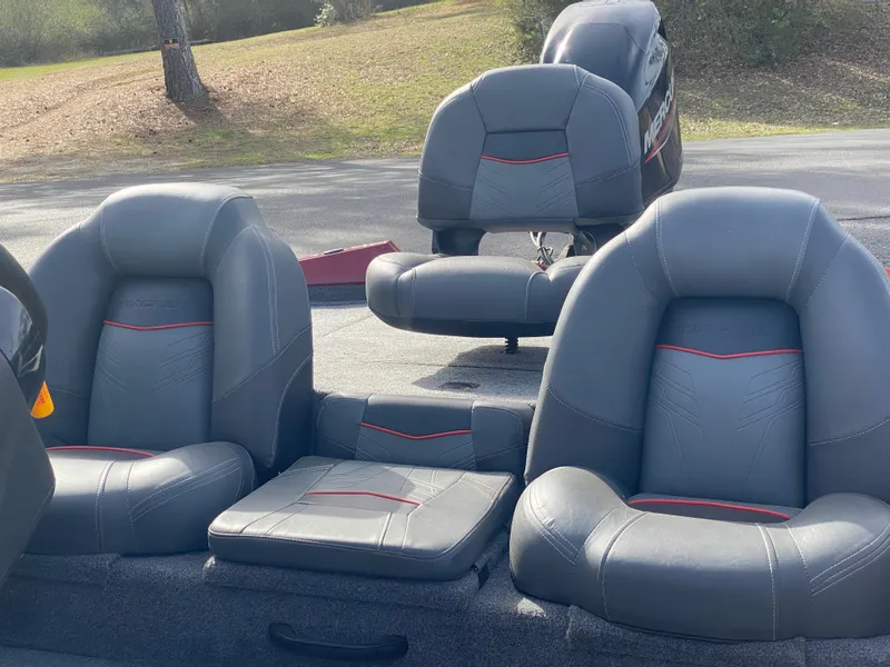 Slide: The Image of 2022 Tracker Pro Team 175 TXW boat seats with gray upholstery and red accents. - 5