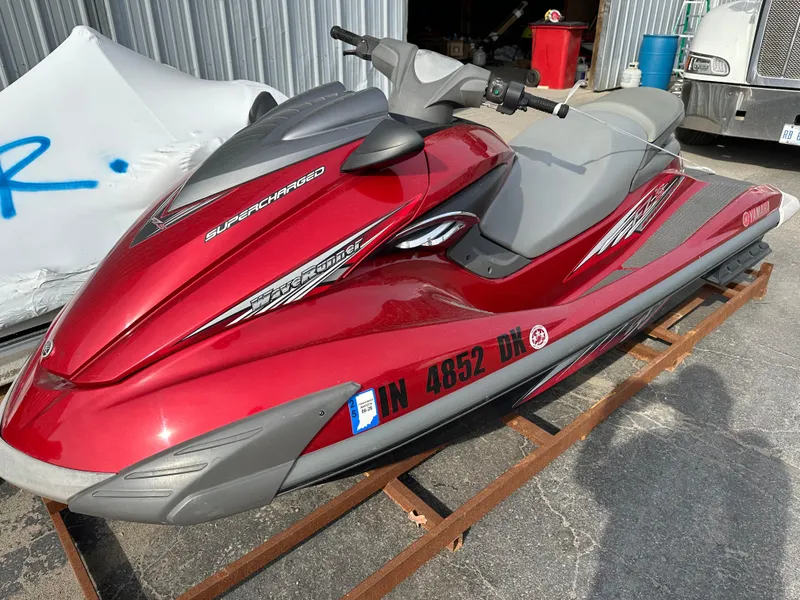 The Image of 2009 Yamaha WaveRunner FZS in red, parked on a metal stand outdoors. - 0