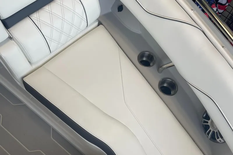 Slide: The Image of 2025 Regal LS4 Surf boat interior with white leather seating and cup holders. - 11