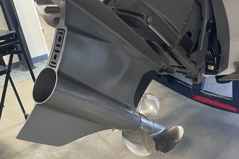 Slide: The Image of 2025 Regal LS4 Surf boat propeller and drive system in a showroom setting. - 13