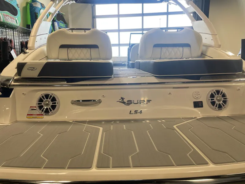 Slide: The Image of 2025 Regal LS4 Surf boat interior with cushioned seating and speakers. - 3