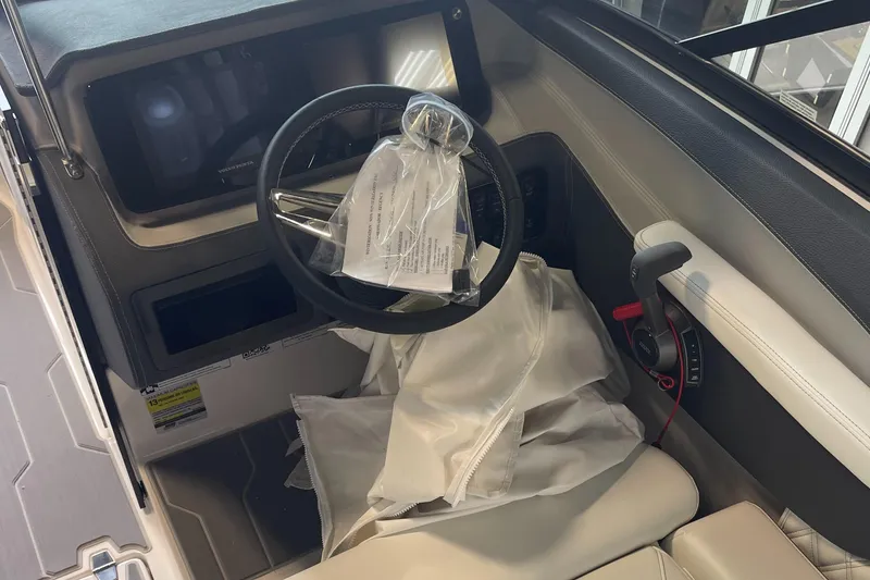 Slide: The Image of 2025 Regal LS4 Surf boat cockpit with steering wheel and controls. - 6