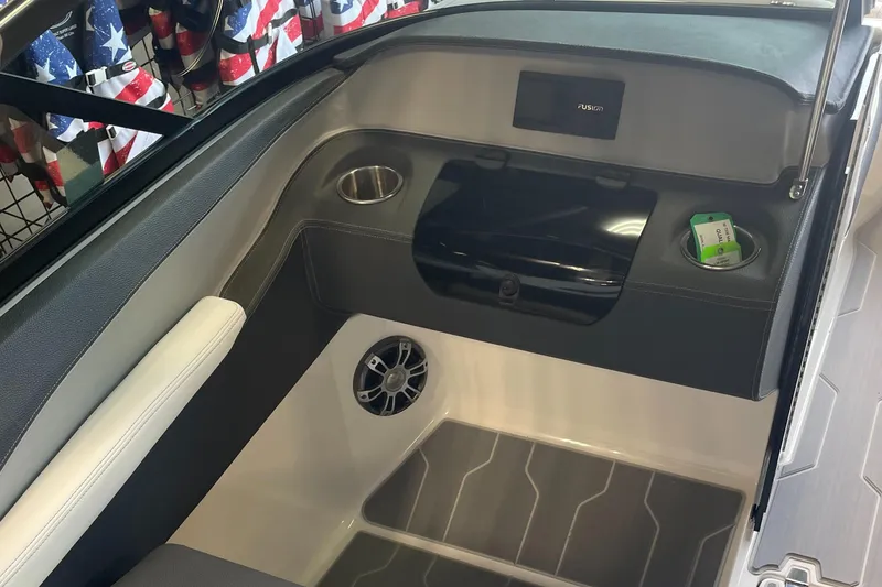 Slide: The Image of 2025 Regal LS4 Surf boat interior with speaker, cup holder, and storage compartment. - 7