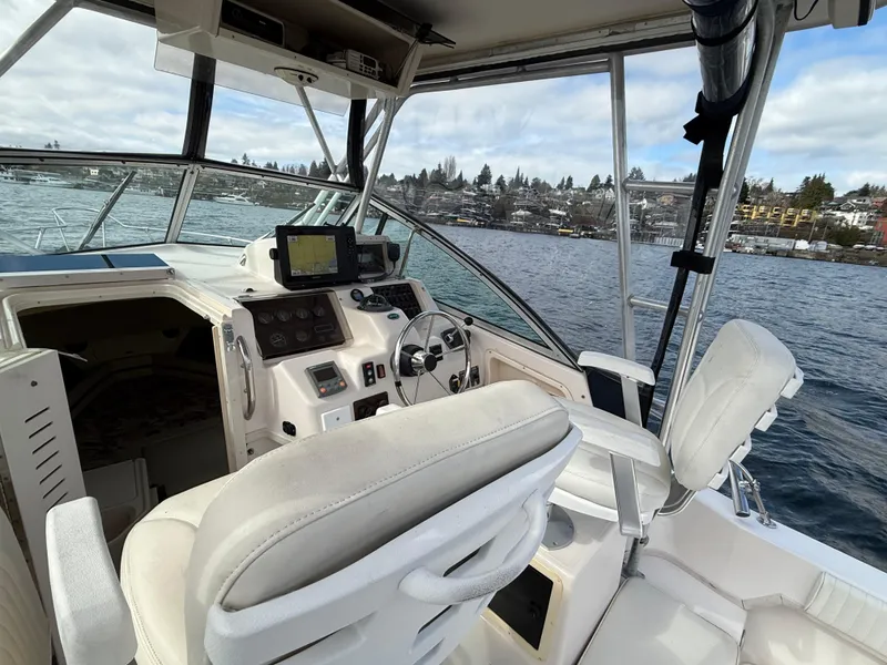 Slide: The Image of 2001 Grady-White Sailfish 274 boat interior with steering wheel and navigation equipment. - 15