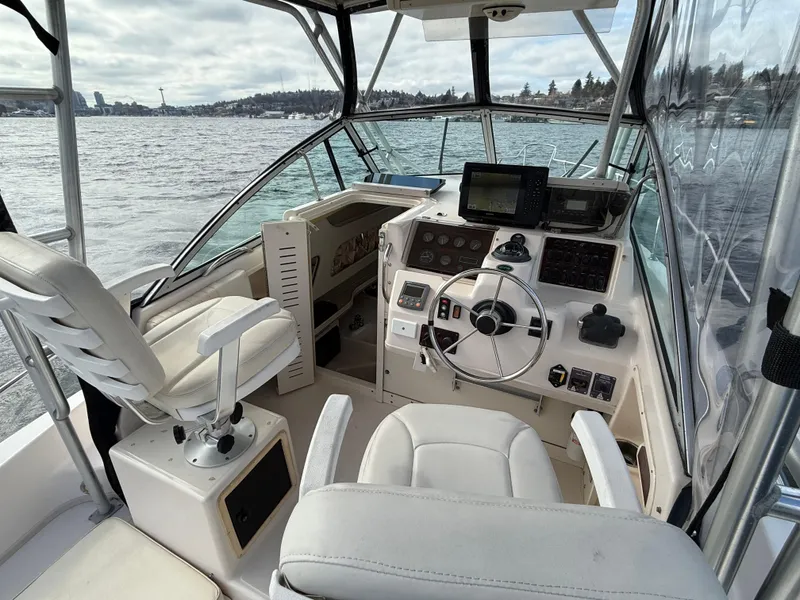 Slide: The Image of 2001 Grady-White Sailfish 274 boat interior with steering wheel and navigation equipment. - 16