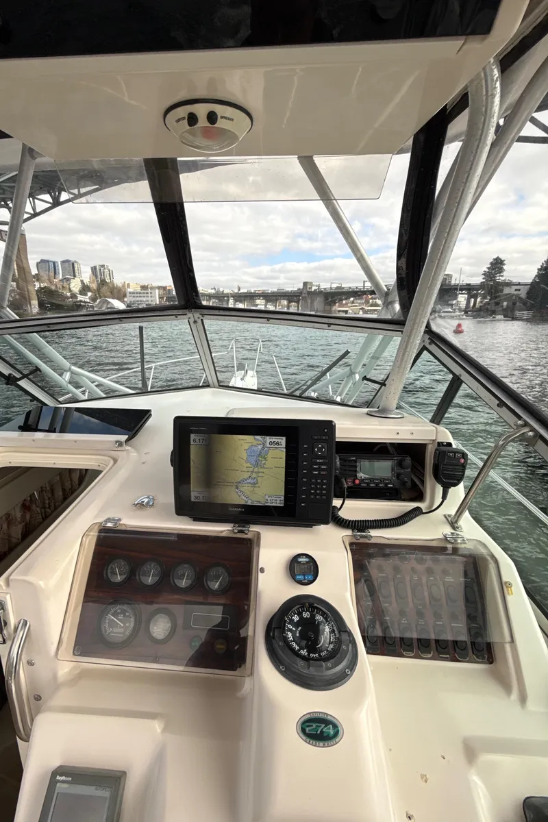 Slide: The Image of 2001 Grady-White Sailfish 274 boat dashboard with navigation equipment on open water. - 17
