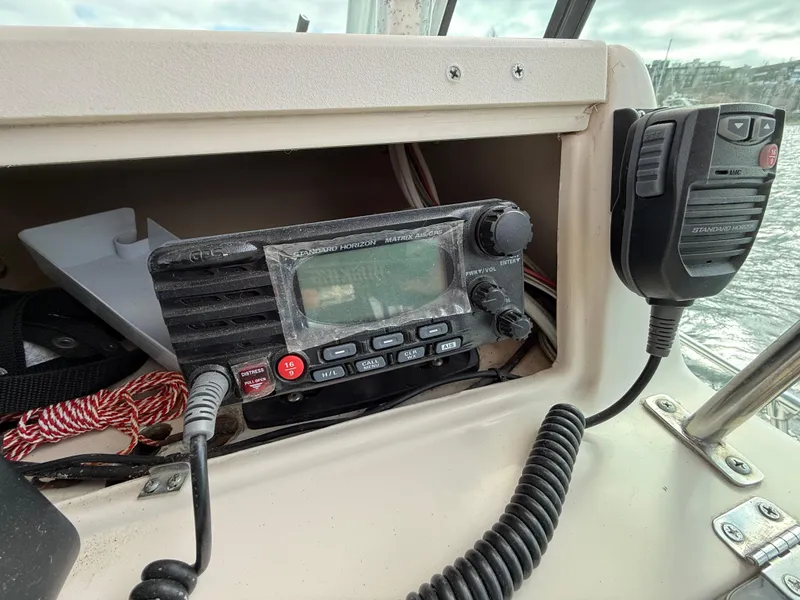 Slide: The Image of 2001 Grady-White Sailfish 274 boat radio and microphone on the dashboard. - 18