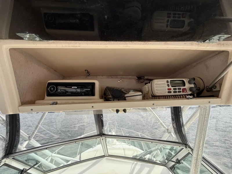 Slide: The Image of 2001 Grady-White Sailfish 274 boat dashboard with radio and control panel. - 22