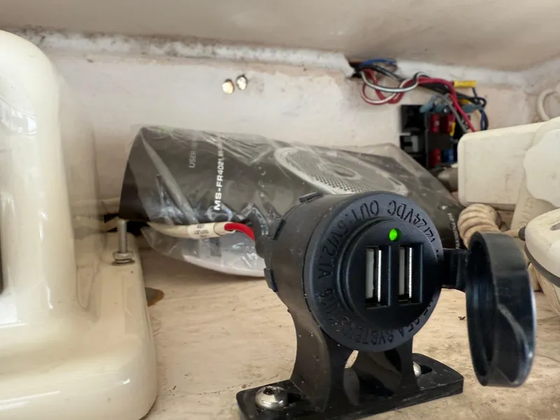 Slide: The Image of USB charger installed on a 2001 Grady-White Sailfish 274 boat dashboard. - 23